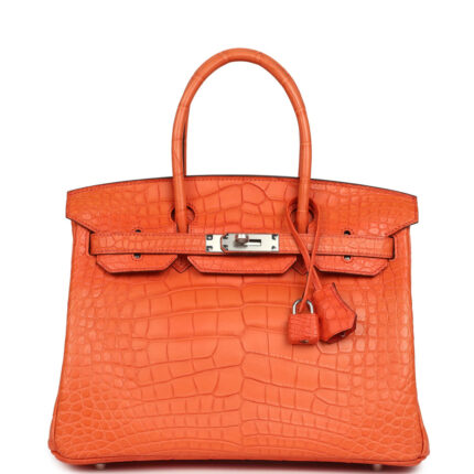 This Birkin is in Orange Poppy Matte Alligator Mississippiensis leather with palladium hardware and features tonal stitching, front flap, two straps with center toggle closure, clochette with lock and two keys, and double rolled handles. The interior is lined with Orange Poppy chevre leather and has a zip pocket with an Hermès engraved zipper pull and an open pocket on the opposite side. Collection: X (2016) Origin: France Condition: Pre-owned; Mint - This bag retains its shape structure. The exterior is clean with overall fading to the alligator skin. There is plastic on the hardware. The interior leather is clean with no signs of wear. Accompanied by: Hermès box, Hermès dustbag, felt, clochette, lock, two keys, clochette dustbag, carebook, raincoat Measurements: 11.75" width x 9.5" height x 6" depth; 4.25" handle drop Free Express shipping We offer free express shipping on all domestic orders via FedEx Express. All shipments are fully insured.